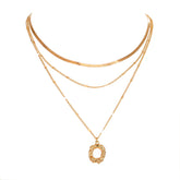 Two gold necklaces on a white background