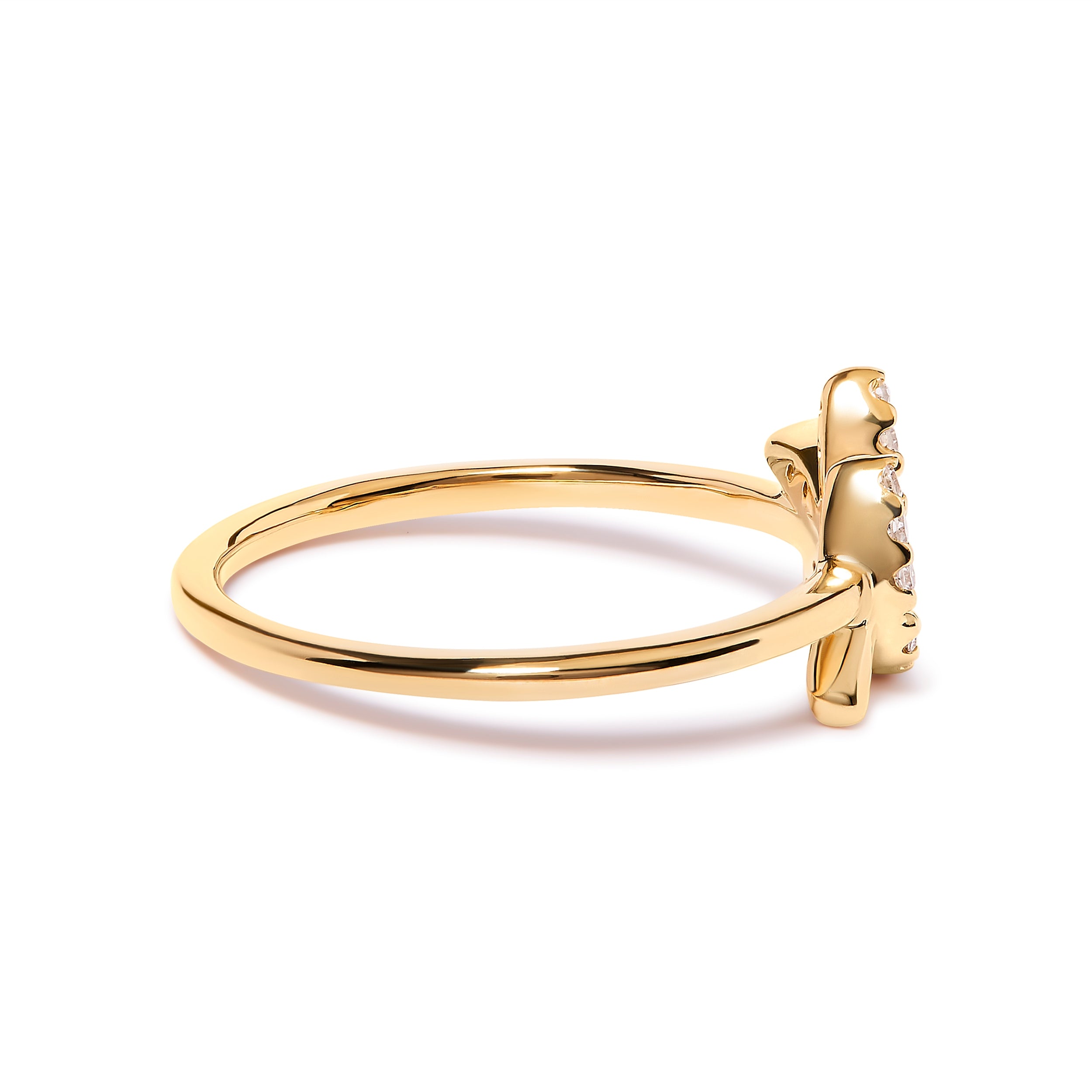 Gold ring with a bow design on a white background