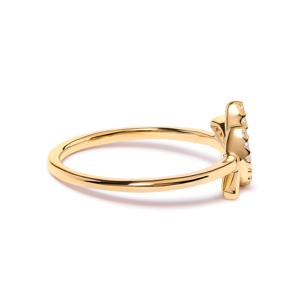 Gold ring with a bow design on a white background