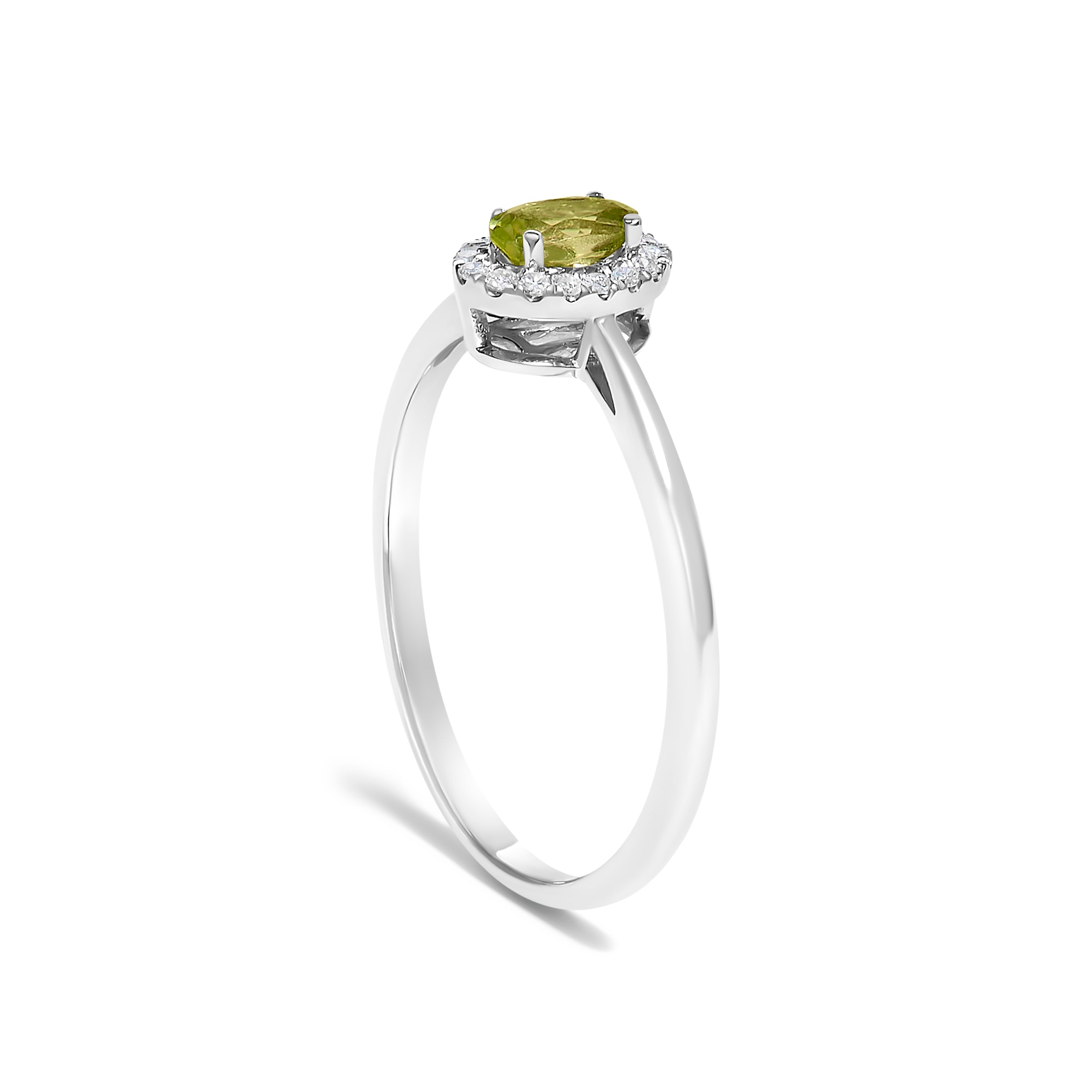 Silver ring with a green gemstone on a white background