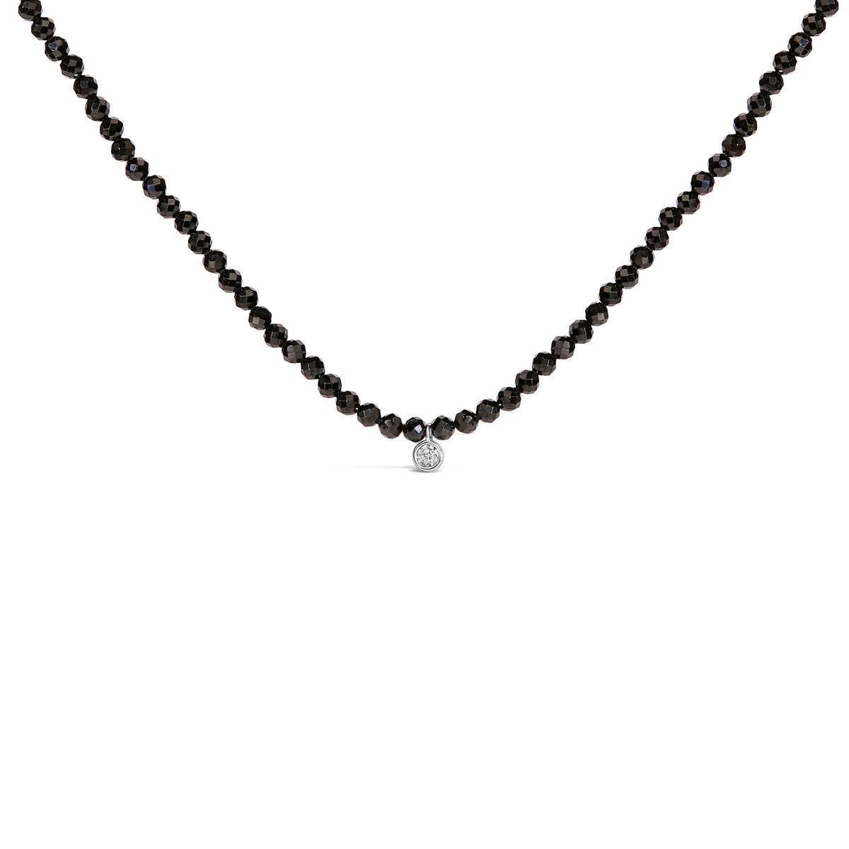 Black beaded necklace with a silver clasp on a white background