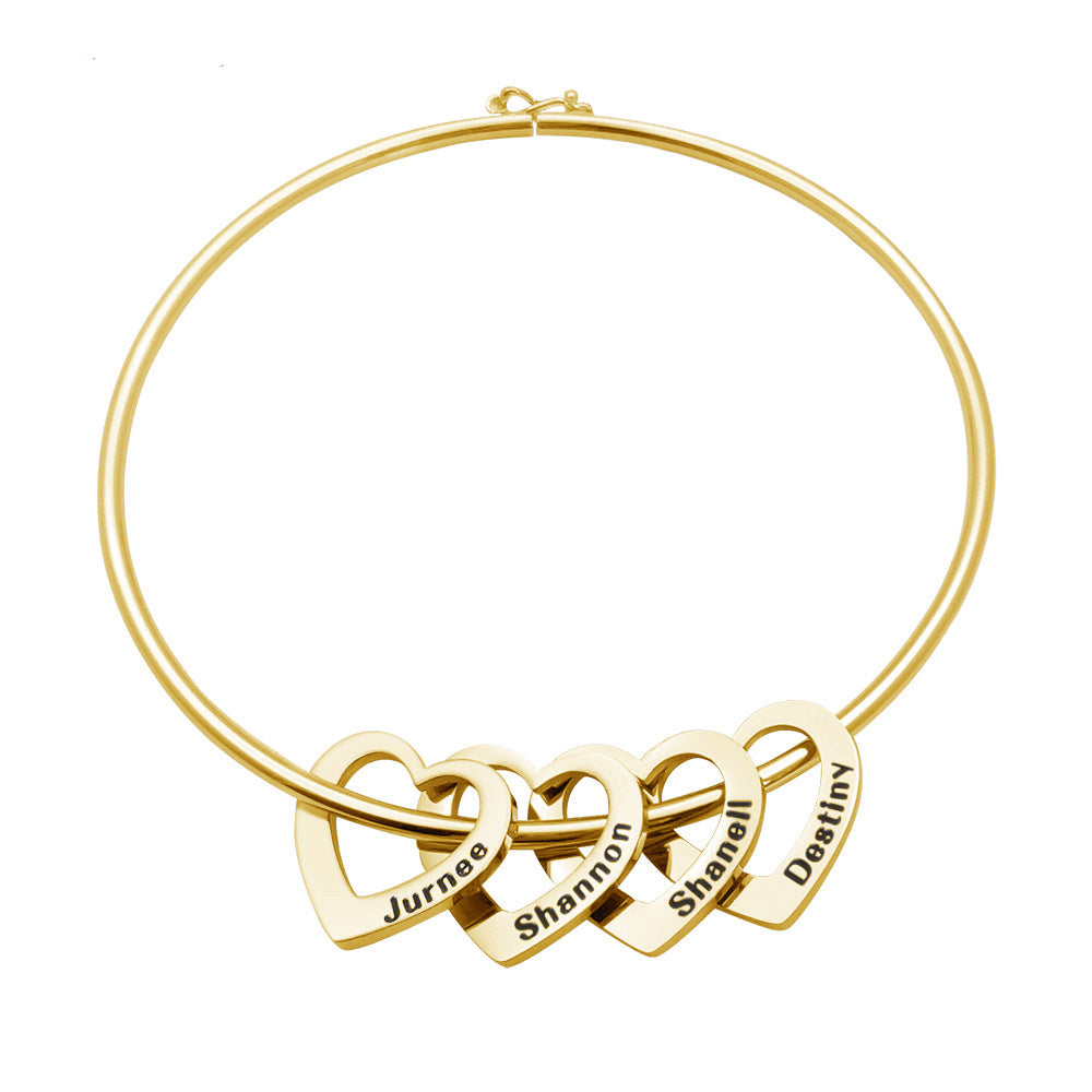 Gold necklace with interlocking heart pendants engraved with names on a white background