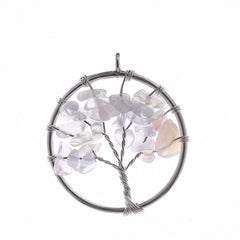 Tree-shaped pendant with multicolored stones on a white background