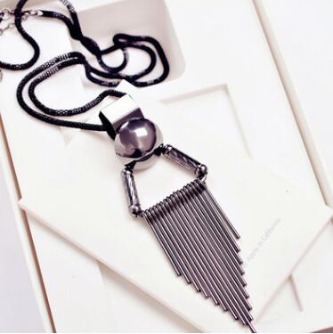 Necklace with tassel pendant on a white surface