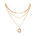 Two gold necklaces on a white background