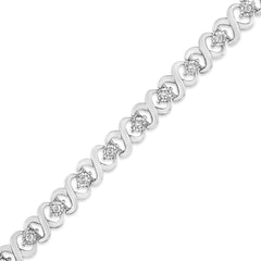 Silver bracelet with diamond accents on a white background