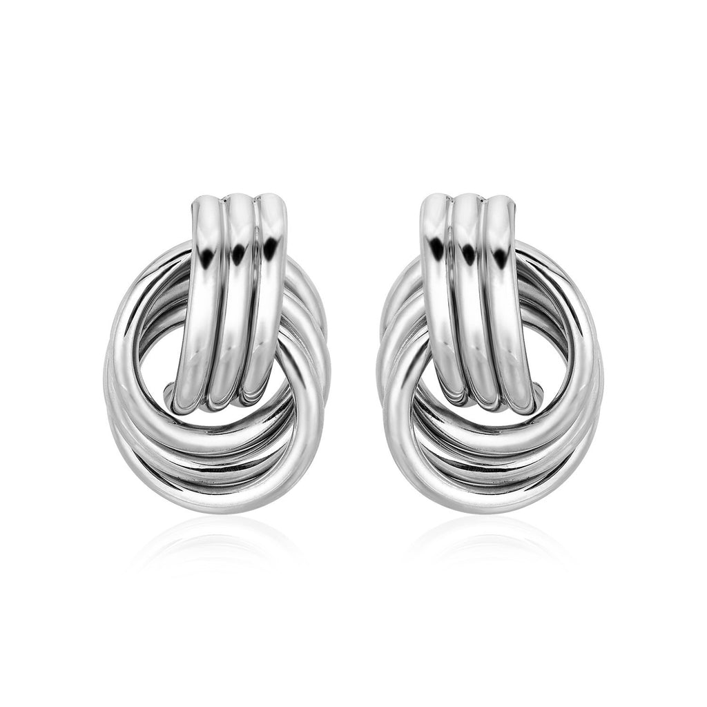 Pair of silver knot earrings on a white background