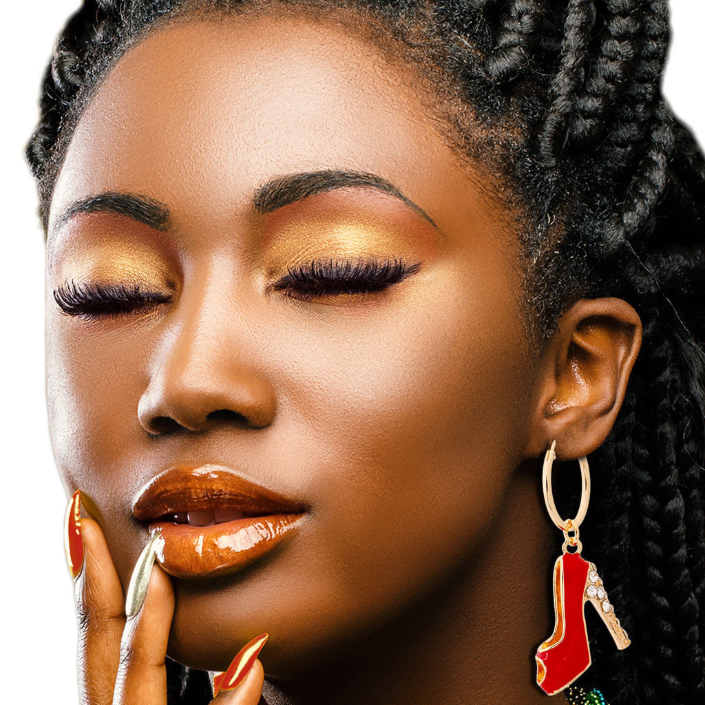 Close-up of a woman with braided hair wearing gold hoop earrings and red lipstick.