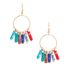 Gold hoop earrings with colorful cylindrical beads on a white background
