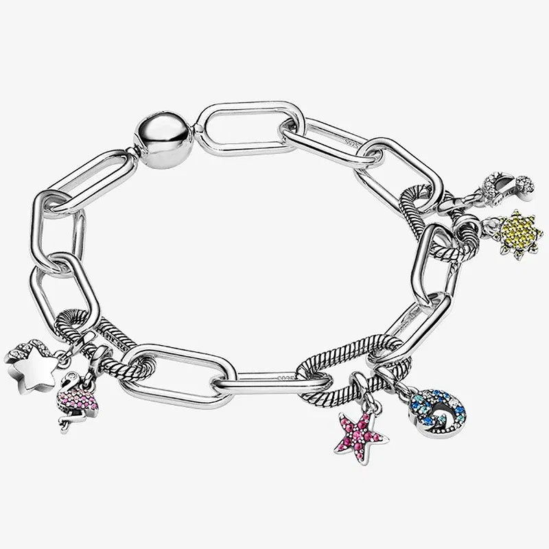 Silver bracelet with various charms on a white background