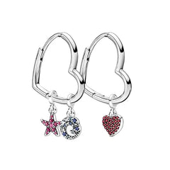 Heart-shaped hoop earrings with star, moon, and heart charms on a white background