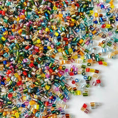 Multicolored beads scattered on a white background