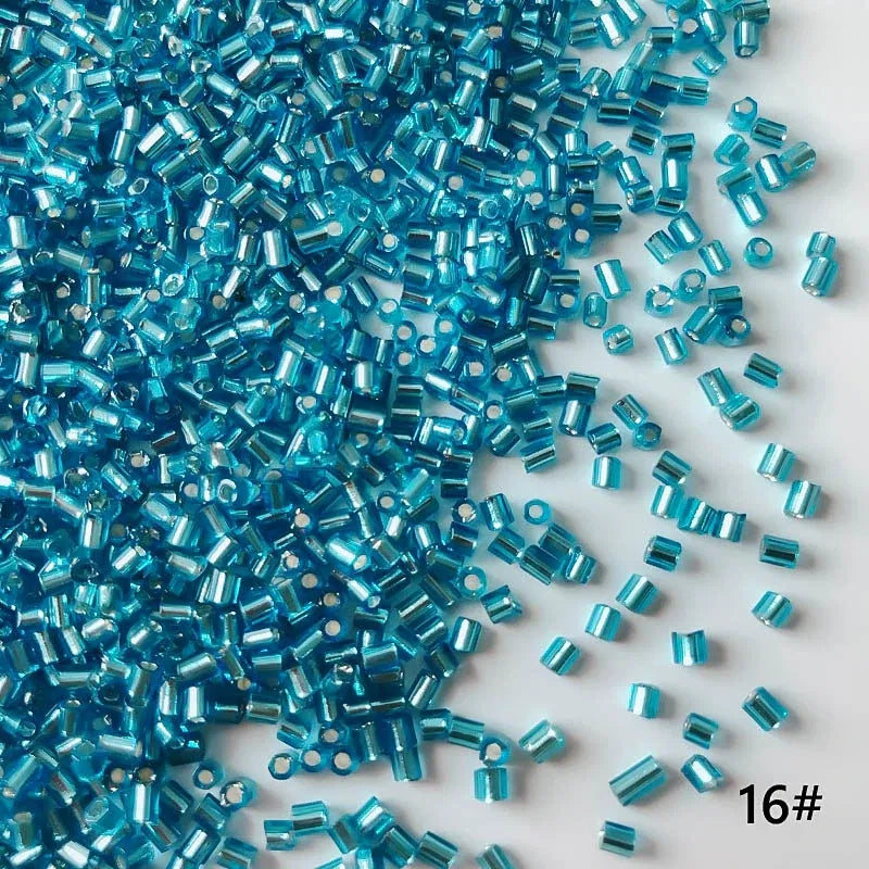 Turquoise glass beads scattered on a white background