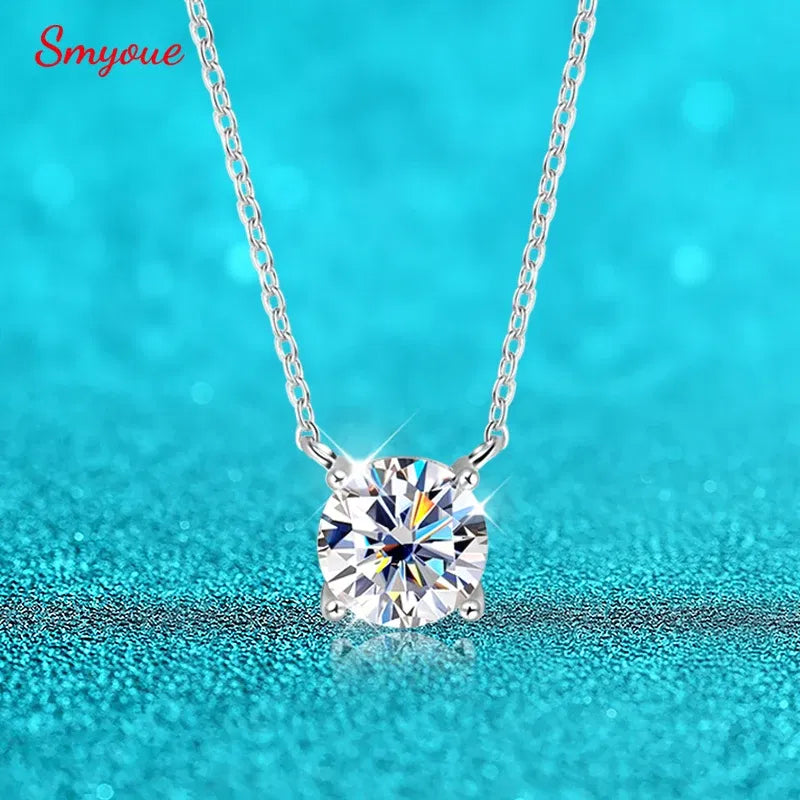 Silver necklace with a large diamond pendant on a turquoise background