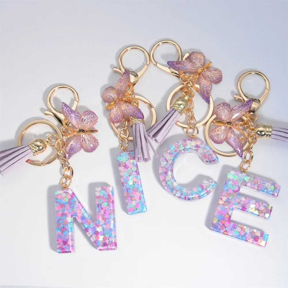Color: Dark Brown - Fashion Tassel Butterfly 26Letter Keychain Colorful Love Heart Filled Resin Alphabet Keyring Women Girls Car Bag Phone Pendant