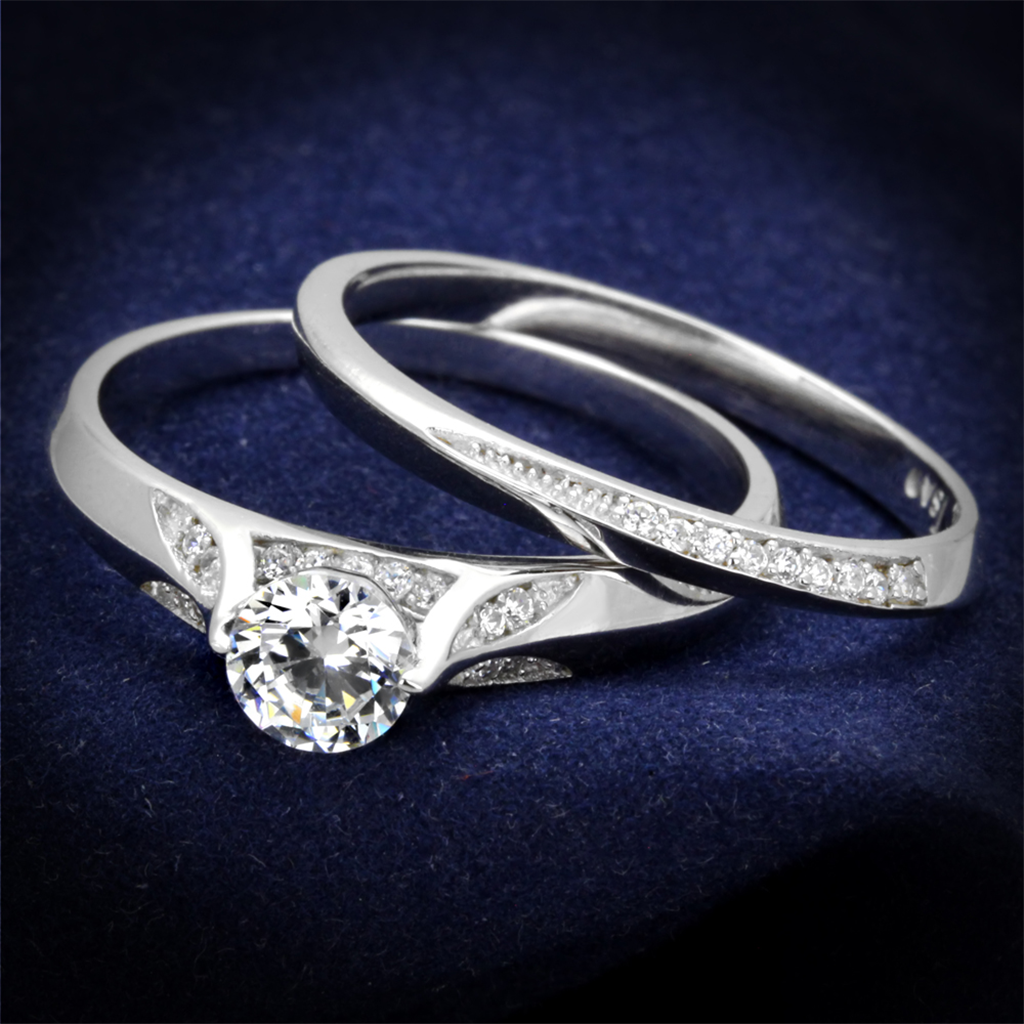 Two silver rings with diamond accents on a dark blue background